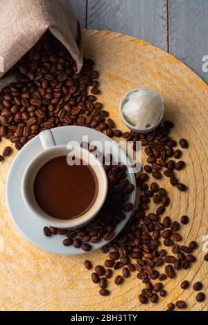 Small Cup Of Coffee And Roasted Coffee Beans With Retro Wooden Manual