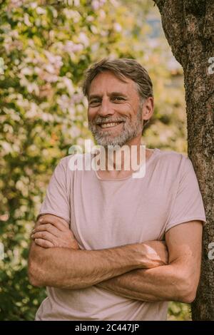 Waist Up Portrait Of Mature Bearded Artist Standing With Arms Crossed