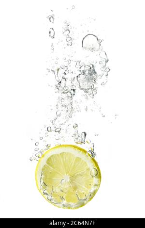 Fresh Lemon Dropped Into Water With Bubbles Isolated On White Stock