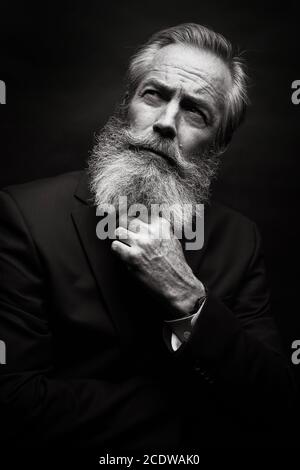 Mature Male Model Wearing Suit With Grey Hairstyle And Beard Stock