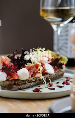 Delicious Bruschetta With Slices Of Tomatoes On A White Plate Closeup