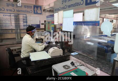 Delhi Metro Employee Seen At The Ticket Counter While A Passenger