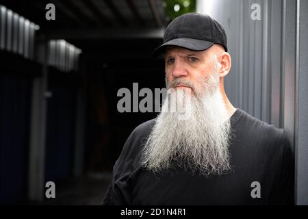 Mature Bearded Hipster Man Thinking With Mask For Protection From