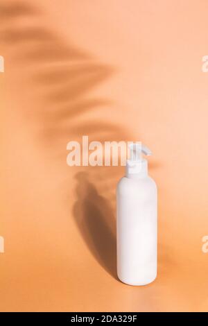 Mock Up Glass Pump Bottle On A Stone Podium On A Beige Background