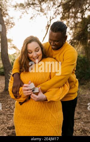 Happy Man Holding An Engagement Ring Box In His Hand And A Bouquet Of