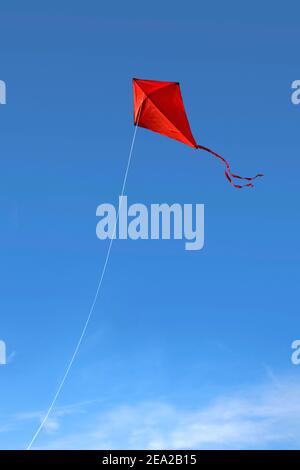 Bright Red Kite Against A Blue Sky Stock Photo Alamy