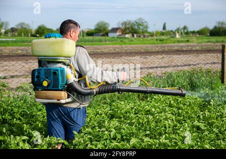 Farmer Sprays Pesticides On Plantation Use Of Chemicals For Protection