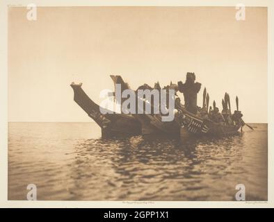 Native American Indians Canoeing In A Traditional Dugout Canoe At The