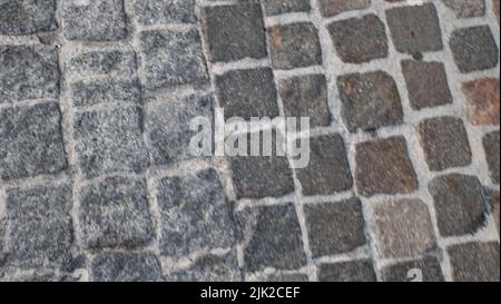 Old Pavement Of Granite Background Top View On Stone Road Close Up