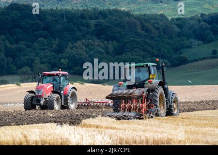 Farmers Ploughing And Cultivating An Arable Field After Harvest North