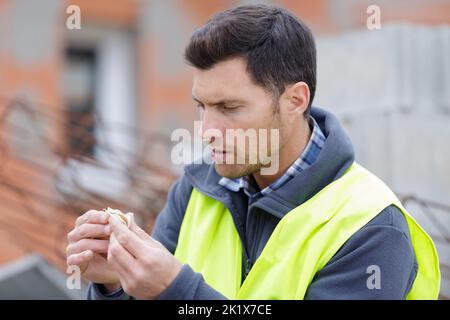 Happy Builder Smoking Cigarette On Construction Site Stock Photo Alamy