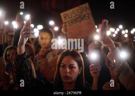 Protesters Hold Up Their Phones With Flashlights Lit During A Protest