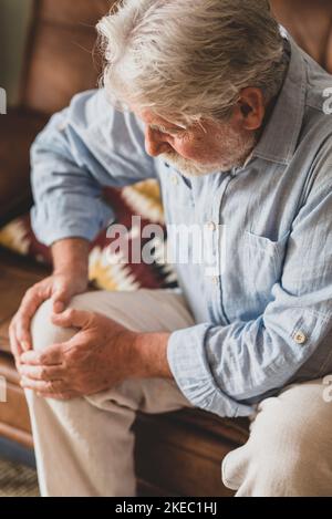 A Man Grabbing His Knee In Pain From Exercising An African American