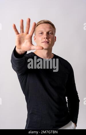 Attractive Blonde German Model In A Black Sweater On A White Background