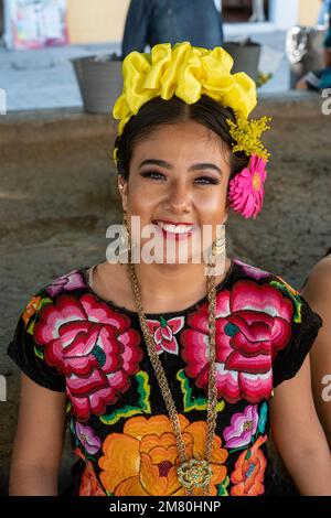 A Woman Dressed In Traditional Attire Sings Religious Songs Near