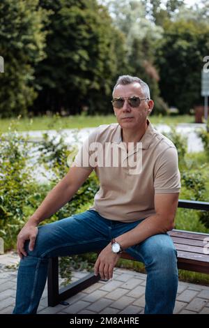 Handsome Mature Gray Haired Man With A Beard In A Shirt On A White