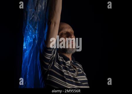 A Bald Mature Man Suffocating With A Transparent Plastic Bag Flying