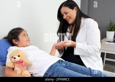 Latina Female Pediatrician Doctor Attends To Her Year Old Girl