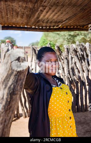 African Village Woman Standing Under The Shade In The Shack Outdoors