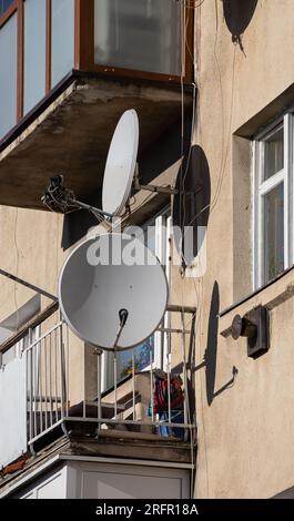 TV Satellite Parabolic Antenna Attached To The Wall Of The House Stock