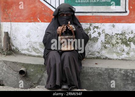 A Kashmiri Warms His Hands On A Fire Pot Kangri As He Sits On His