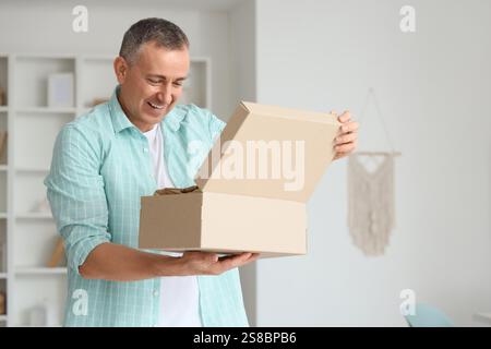 Mature Man Unpacking Box With Shoes In His New Flat Stock Photo Alamy