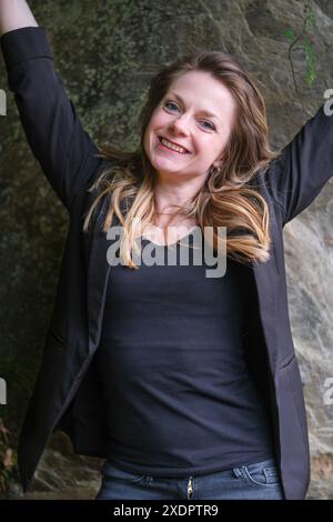 Charming Relaxed Blonde Woman In Hair Curlers Using A Tablet Pc Stock