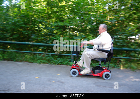 Elderly Man - Pensioner - On Electric Mobility Scooter On City Stock ...