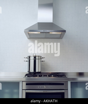 Modern Kitchen Extractor Fans stainless steel extractor fan above pan on hob in modern kitchen Modern Kitchen Extractor Fans stainless steel extractor fan above pan on hob in modern kitchen