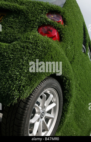 Smart car covered in artificial grass in street London UK Stock Photo