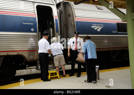 Amtrak Railroad Conductor Assisting Passenger At Deland Fl America