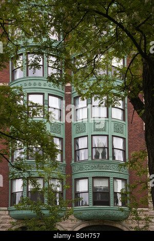 Brick Apartment Building Window apartment windows in building with american flag flying from one Brick Apartment Building Window apartment windows in building with american flag flying from one