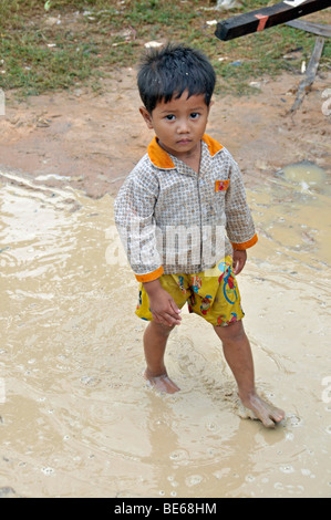 Young local kids boy walking half naked and bare foot in 