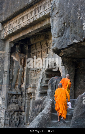 Buddhist Monks Wearing Orange Robes Are Praying With Their Alms Bowls