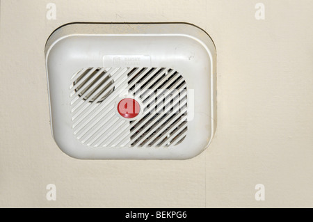 Red fire alarm smoke detector with strobe light mounted on ...