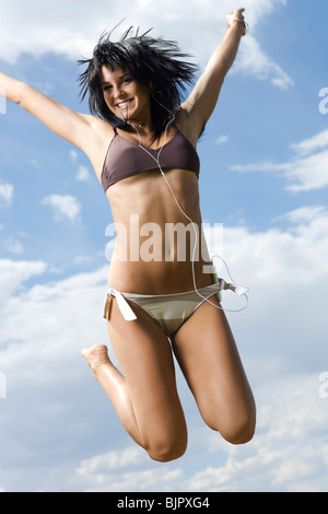 Two Women In Bikini Jumping With Their Hands Up Stock Photo Alamy