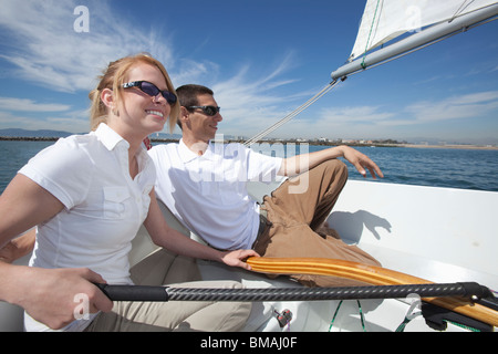 http://l450v.alamy.com/450v/bmaj0f/young-couple-relax-on-deck-of-sailing-boat-bmaj0f.jpg