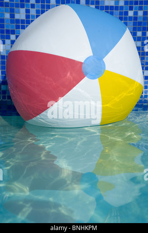 Beach Ball In Water colorful beach ball floating on water of swimming pool stock photo Beach Ball In Water colorful beach ball floating on water of swimming pool stock photo