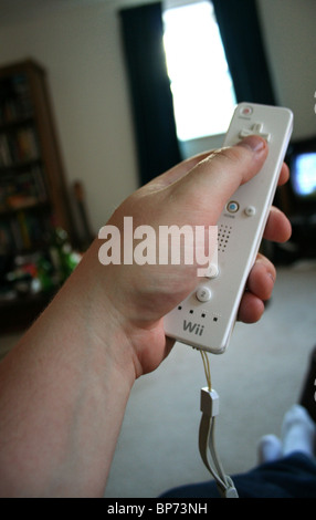 Hand Holding Nintendo Wii Controller Pointing At The TV Stock Photo Alamy