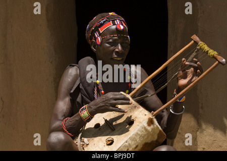 Tribal Man Playing Traditional Musical Instrument Dholak Or Drums Stock