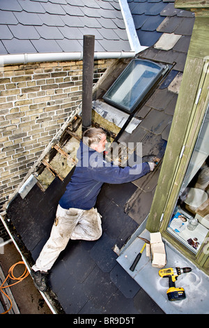 Leaky Roof a plumber replace old leaky roof with new slates stock photo Leaky Roof a plumber replace old leaky roof with new slates stock photo