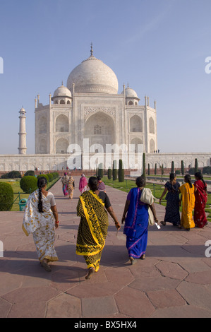 Women In Yellow Saris Walking Across The White Marble Floor Of The Taj