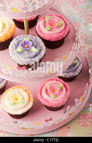 Pink And Yellow Cup Cakes On Background With Flowers Stock Photo Alamy