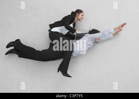 Business Woman Sitting On Man S Back Stock Photo Alamy