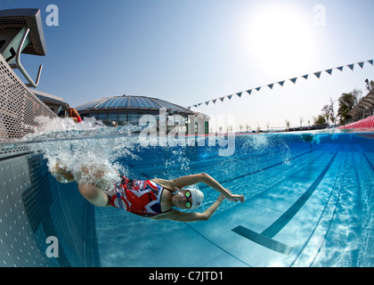 Olympic Swimming Pool Underwater a female swimmer training in an open air olympic swimming pool Olympic Swimming Pool Underwater a female swimmer training in an open air olympic swimming pool