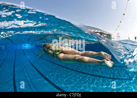Olympic Swimming Pool Underwater underwater shot of female swimmer in action inside swimming pool Olympic Swimming Pool Underwater underwater shot of female swimmer in action inside swimming pool