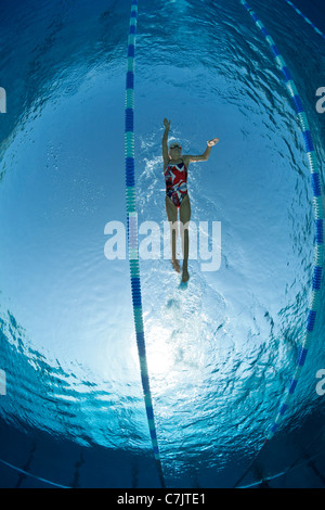 Olympic Swimming Pool Underwater a female swimmer training in an open air olympic swimming pool Olympic Swimming Pool Underwater a female swimmer training in an open air olympic swimming pool
