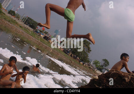 Boys swim in polluted river at slum area in Jakarta Stock 