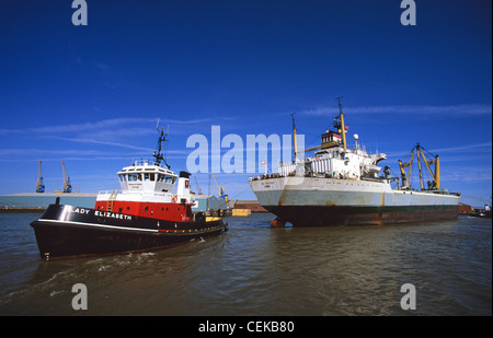 towing a boat into the us tug boat towing freighter into lock at the port of hull towing a boat into the us tug boat towing freighter into lock at the port of hull
