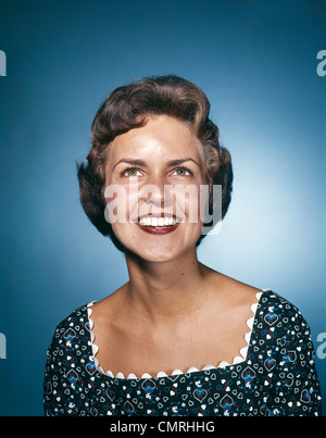 1960s smiling brunette woman in print dress looking up cmrhhg